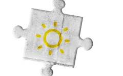 Sonne auf grauem Puzzleteil