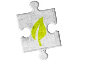 Grünes Blatt auf grauem Puzzleteil